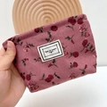 Pink corduroy makeup bag with red roses and Time To Party label held by hand - Small / Red Rose
