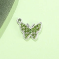 Macro shot of silver alloy butterfly pendant with sparkling green rhinestones for DIY jewelry - Light Green Butterfly UV Silver Plated