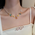 Floral and fruit beaded necklace with orange, yellow, and blue resin charms on model - 16# Pearl Lily of the Valley Flower Leaf Heart Round Bead Necklace