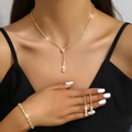 Detail of elegant gold jewelry set with sparkling crystals on a female model - 446+785 3-Piece Set Gold