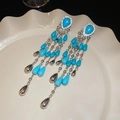 Detailed macro of silver flower earrings with turquoise beads and cascading long tassels - 11# Silver Needle-Silver-Blue