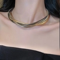 Detail view of multi-layer snake bone necklace in mixed gold and silver tones on a model - Mixed Color Wound Necklace