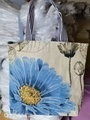 Retro canvas tote bag featuring large blue floral print and striped woven handles - Orchid