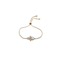 Detail of adjustable gold Hamsa and Evil Eye bracelet with blue zircon crystals - Box Chain