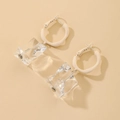 Macro detail of clear acrylic ice cube drop earrings with minimalist cream round studs - Geometric Style (HE5810)