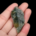 Green natural agate stone leaf pendant with carved veins held in hand for size - India Agate