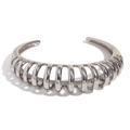 Polished silver stainless steel open bangle featuring a hollow ribbed wave design - Silver