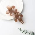Elegant U-shaped hair clip with brown double flower resin design on a porcelain plate - Coffee UV