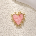 Macro shot of gold-plated heart pendant with pink pearlescent enamel and bead trim - Gold Pink Enamel Heart