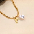 Elegant gold chain necklace with baroque pearl and letter P pendant on beige fabric - Letter P Necklace