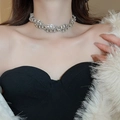 Close-up of sparkling rhinestone twisted choker necklace on model's neck for elegant look - Silver