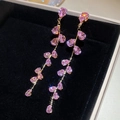 Détail de boucles d'oreilles en zircon rose avec pompon doré dans une boîte noire - 8# Tige en Argent Frange Rose