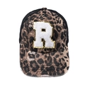 Detail of leopard print baseball cap featuring a white fuzzy R patch with gold sequins - Letter R (Black Leopard)