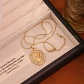 Detail of vintage French cameo pendant necklace with pearls inside a beige velvet jewelry box - White