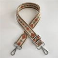 Close-up of geometric jacquard woven bag strap with silver metal swivel hooks - No.2 Green Brown + Silver Buckle