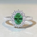 Macro shot of oval green gemstone ring with white diamond halo and pavé silver band - US 5 / Paraiba Green - Silver