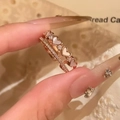 Macro detail of rose gold heart rings with mother of pearl and zircon micro-pave - Rose Gold