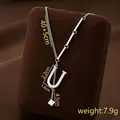 Silver-colored U-letter tassel necklace in stainless steel with asymmetric chain detail - Letter U / Silver