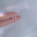 Elegant 925 sterling silver heart stud earrings with milgrain edge held by hand - Small Solid Heart / Silver