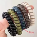 Close-up of high-elastic spiral phone cord hair ties in black, olive, navy, and brown - Blue