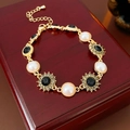 Vintage gold sunflower bracelet with pearls and rhinestones on a red jewelry box - Eco-friendly Gold (Black Stone)