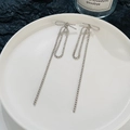 Elegant silver tassel earrings with bowknot and rhinestones on a white plate - Silver Bowknot Rhinestone Tassel (5985)