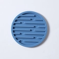 Minimalist round blue silicone coaster with non-slip geometric stripes and heat resistance - Drain Style / Blue