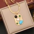 Detail of gold necklace pendant with turquoise, pearl and cat-eye stones on a beige box - 1# Green Necklace