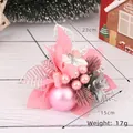 Pink Christmas floral pick with matte ornaments and pine cones on a white wood background - Style 12