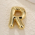 Macro view of gold plated balloon style letter R pendant with mirror polished finish - Letter R