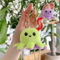 Close-up of reversible octopus plush keychain showing flip function and metal clip - Green to Purple - Gold Hook