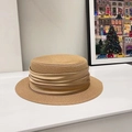 Detail of the champagne pleated ribbon and woven texture on this stylish straw hat - Camel/Khaki Ribbon