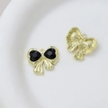 Macro detail of bow-shaped black heart pendant with golden alloy frame for DIY jewelry - Style 34