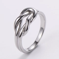 Macro shot of silver knot ring showing detailed metallic texture and polished finish - US 6 / Twisted Knot / Silver