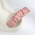 Detail of pink ruched PU leather hair clip on a minimalist white ceramic tray - Pleated Pink
