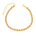 Detailed view of gold bracelet featuring red cubic zirconia and heart charm extender - Orange