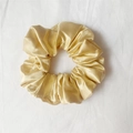 Elegant champagne gold satin scrunchie with glossy silk texture for versatile hair styling - Apricot Yellow