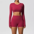 Detail view of burgundy seamless yoga set featuring long sleeve top and high waist shorts - S / Top And Bottom / Carmine
