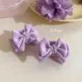 Macro detail of two lavender satin bow hair clips with 5.3cm length and glossy texture - Single Piece / Purple