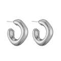 Detailed macro view of irregular organic silver metal hoop earrings with high polish finish - White Gold C-Shape