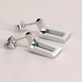 Polished silver stainless steel rectangular geometric stud earrings on a textured background - Steel