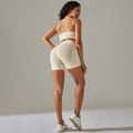 Detail of seamless ribbed sports set showing crossover back bra and high-waist shorts - S / Beige