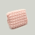 Portable pink seersucker bubble texture makeup bag with a secure zipper closure - Pink