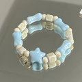 Blue and beige ceramic beaded bracelet with star and bone charms on mirror surface - Xingchuan (1007-01星川)