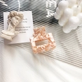 Square acetate hair claw clip with pink and cream marble texture in elegant display - Floral Milk Coffee