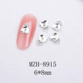 Macro shot of 6x8mm heart-shaped cat-eye nail art crystals with silver metal base - Silver Heart Style With White Crystal (8915)
