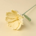 Close-up of handmade crochet sunflower with detailed yellow petals and green stem - Galsang Flower / Yellow