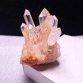 Natural white crystal cluster specimen with orange-brown mineral base on a black background - Approx. 300-400g