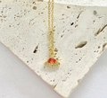 Macro shot of watermelon pendant necklace with red crystals on beige stone background - Gold Watermelon Necklace White Zircon