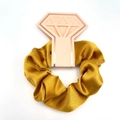 Golden satin silk scrunchie on a pink diamond card, elegant hair accessory for women - Gold